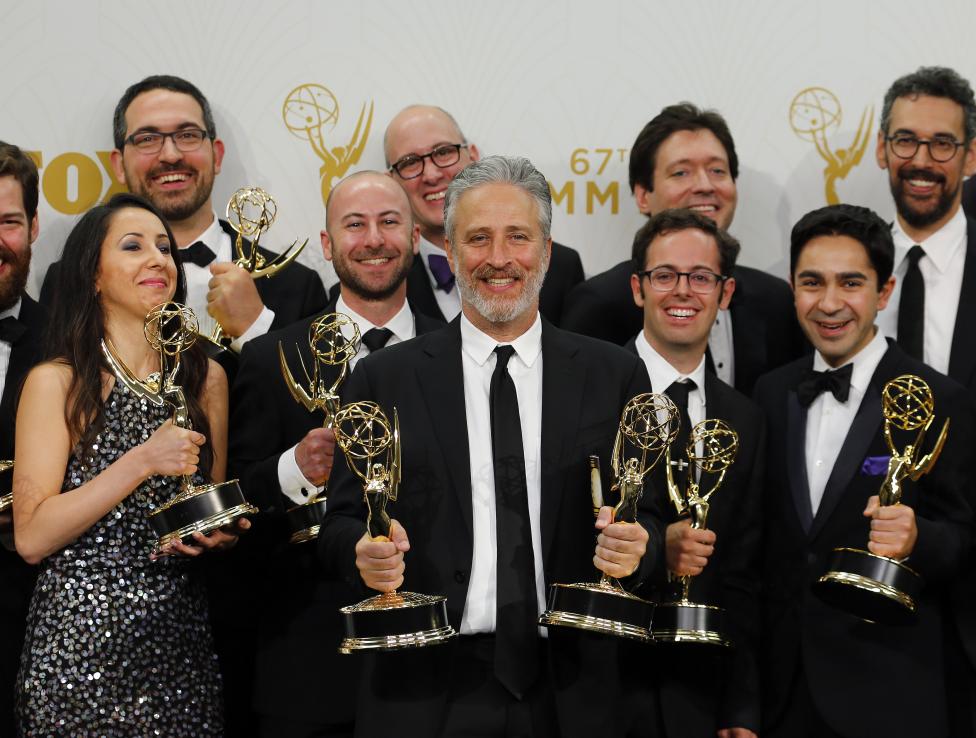 Producers, writers and crew, including Jon Stewart, hold their awards for Outstanding Writing For A Variety Series and Outstanding Variety Talk Series for Comedy Central's "The Daily Show With Jon Stewart" backstage. REUTERS/Mike Blake