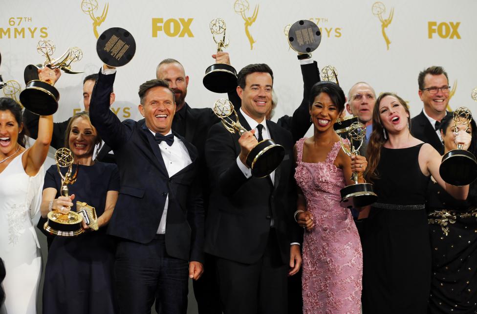 Producers and crew of NBC's "The Voice," including executive producer Mark Burnett and host Carson Daly hold their awards for Outstanding Reality-Competition Program backstage. REUTERS/Mike Blake